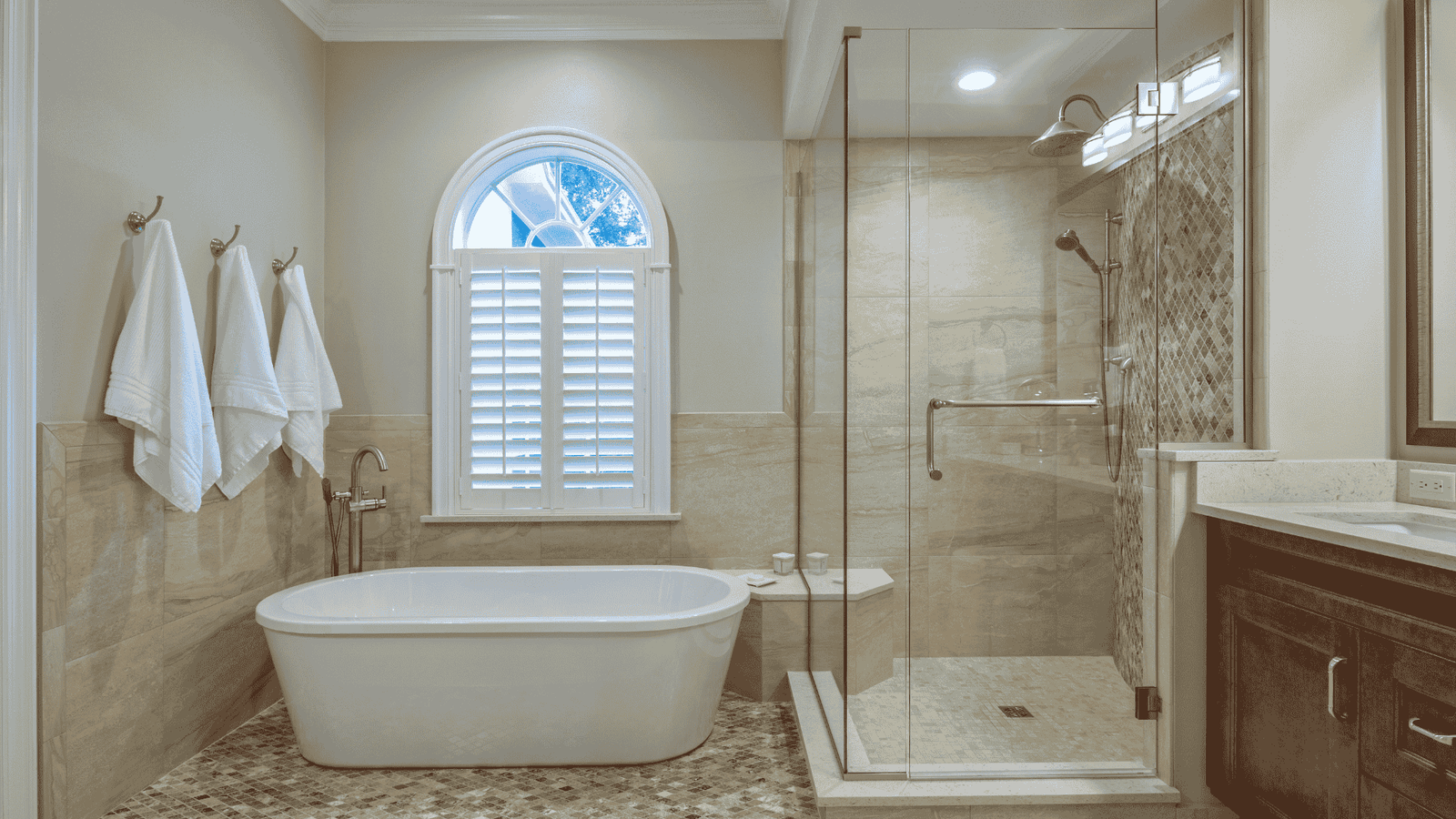 Newly remodeled shower with clean wall panels, grab bars, and modern fixtures